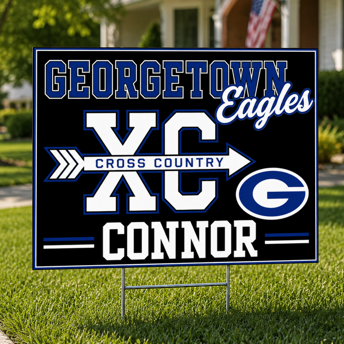 A custom yard sign for Georgetown Eagles Cross Country, featuring a black background with blue and white lettering that reads 'GEORGETOWN Eagles XC CROSS COUNTRY G Connor', displayed on a green lawn in front of a house.