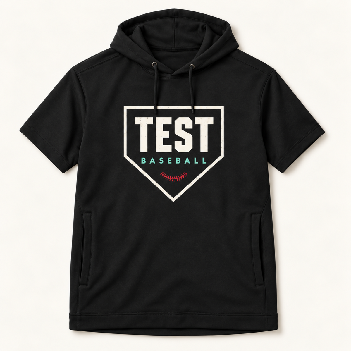 A black short-sleeve pullover hoodie with a front kangaroo pocket and a large graphic on the chest reading 'TEST BASEBALL' inside a white home-plate outline with a small red baseball seam detail, shown on a light off-white background.