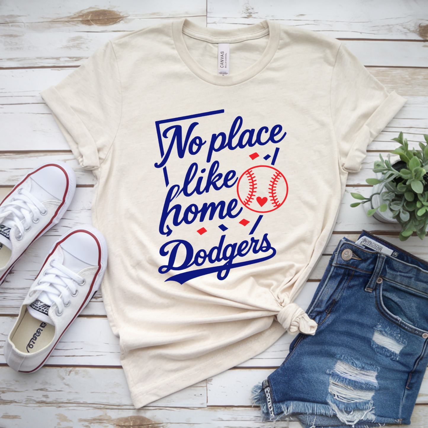 Cream Leander Dodgers No Place Like Home baseball shirt with royal blue script, red baseball and heart design