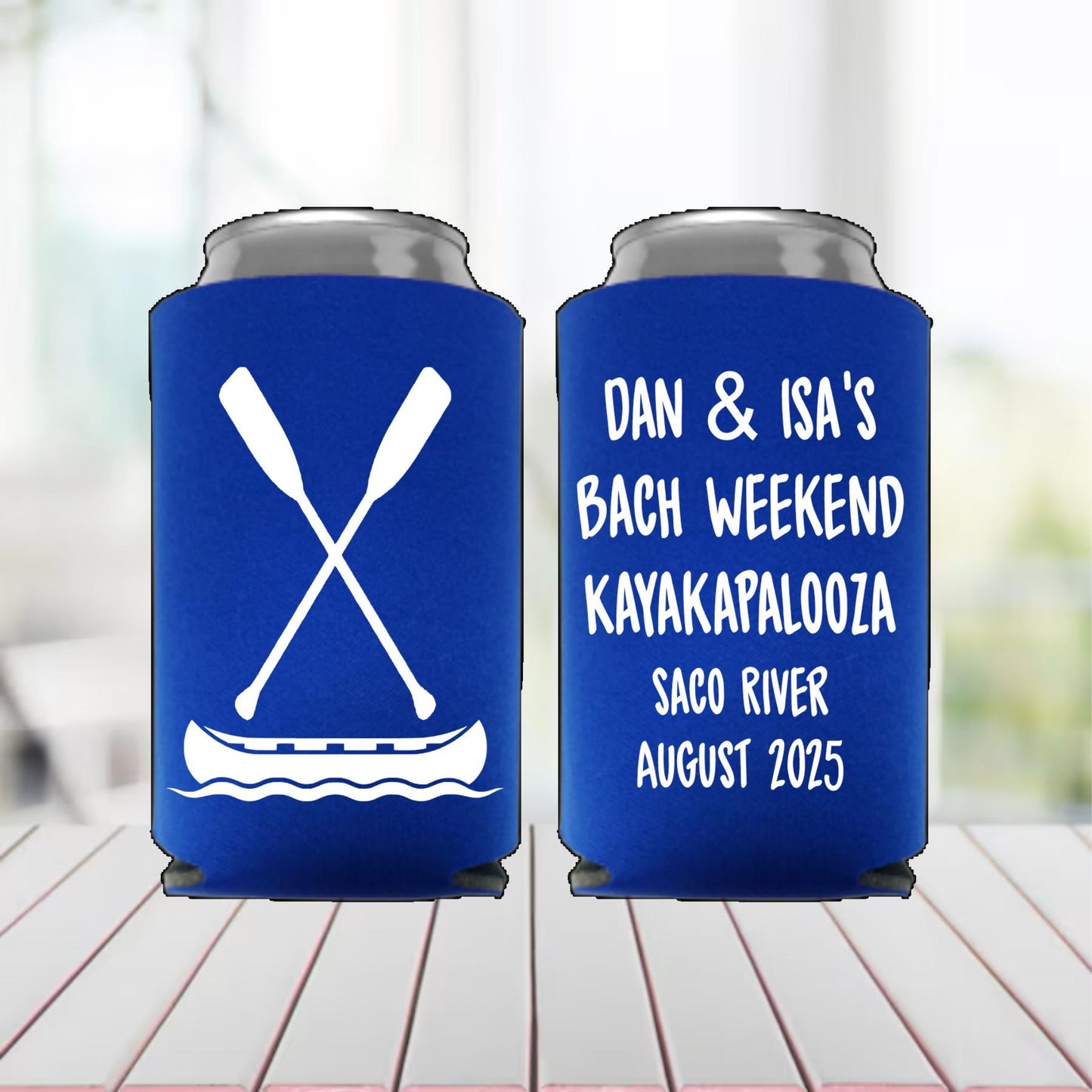 Two blue can coolers with white text and design on a wooden surface.