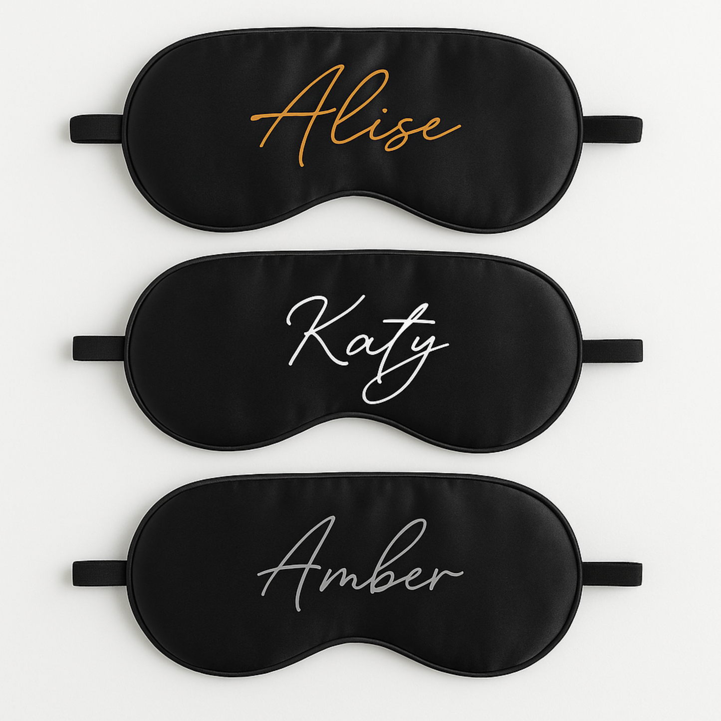 Three black sleep masks with printed names 'Alise', 'Katy', and 'Amber' on a white background.