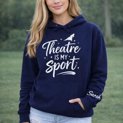 Person wearing a navy hoodie with 'Theatre is my Sport' text, standing outdoors.