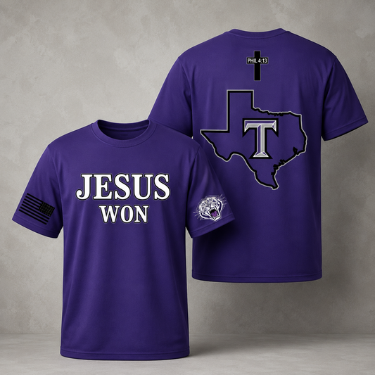 Purple short-sleeve T-shirt shown from both front and back on a gray studio background. The front reads 'JESUS WON' in large white letters, with a black American flag graphic on one sleeve and a small skull-style logo on the other sleeve.