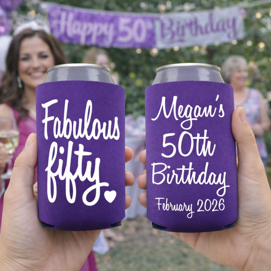 Two purple can coolers with 'Fabulous fifty' and 'Megan's 50th Birthday February 2026' text, held in front of a birthday celebration background.
