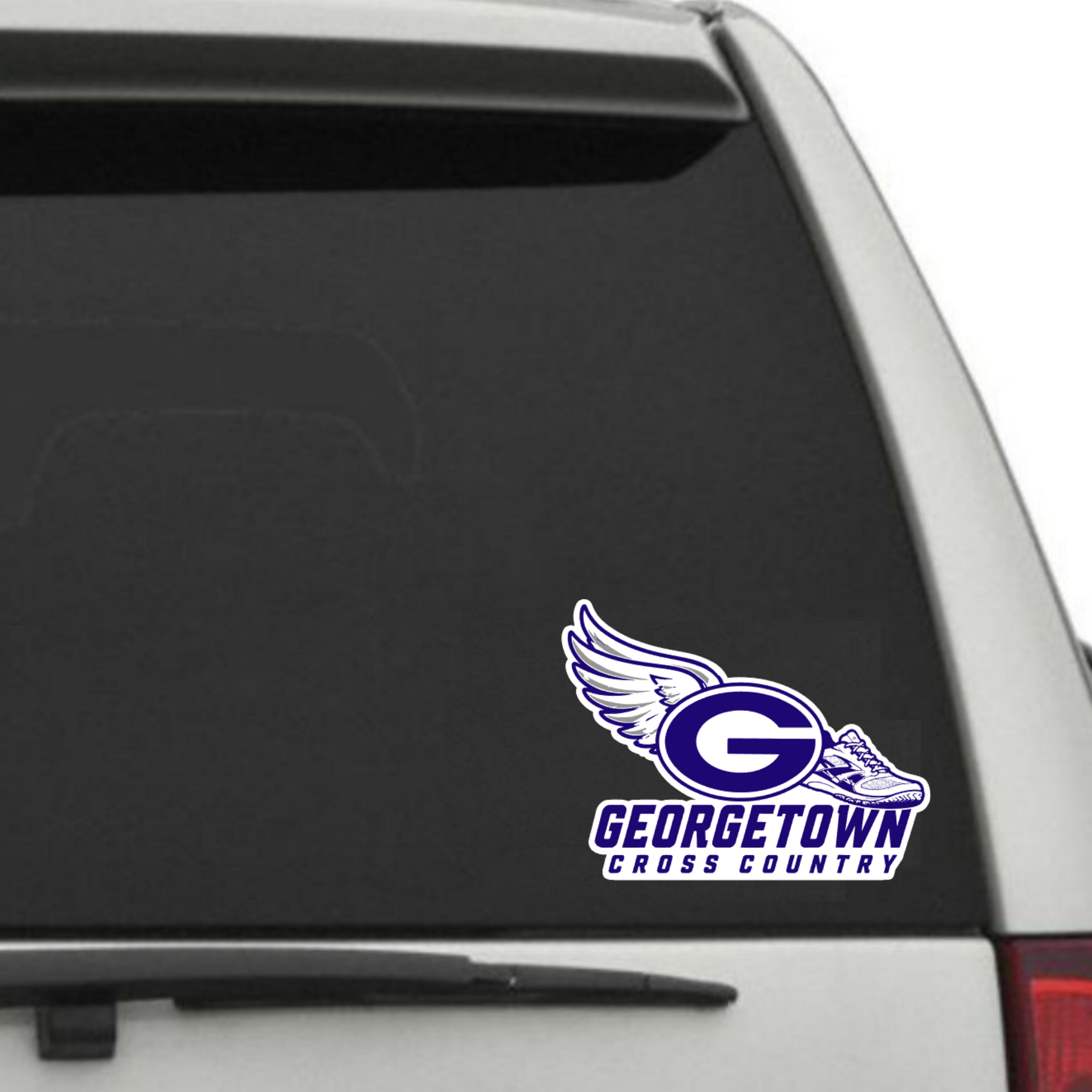 A white and blue Georgetown Cross Country decal with a winged 'G' logo, applied to the rear window of a silver SUV.