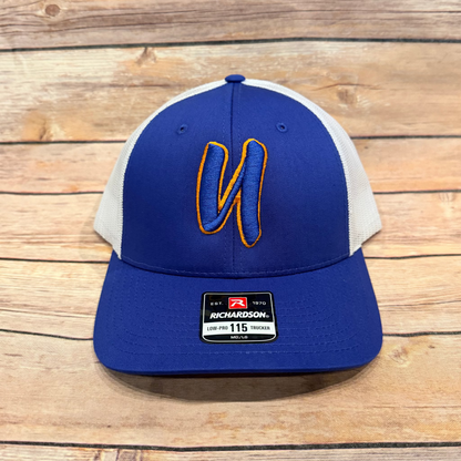 Blue and gray cap with a logo on a wooden surface