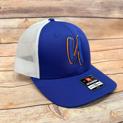 Blue and white cap with a logo on a wooden surface