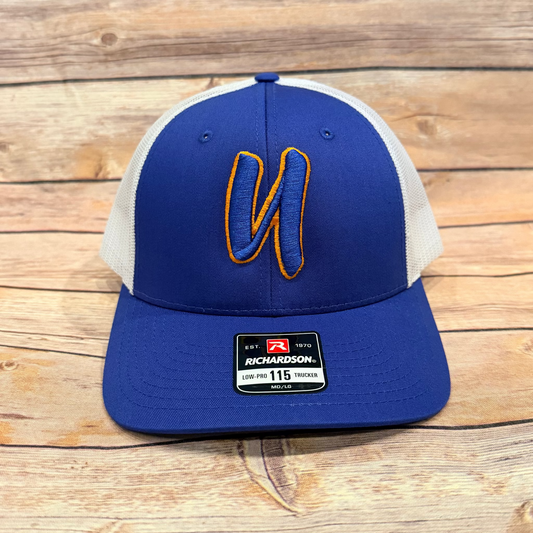 Blue and white cap with a logo on a wooden surface