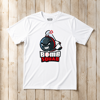 A white short-sleeve t-shirt with a cartoon bomb graphic and the text 'BOMB SQUAD' on the front, laid flat on a light wood plank background. The inside collar shows the brand name 'BLUE EYE TEE SHOP'.