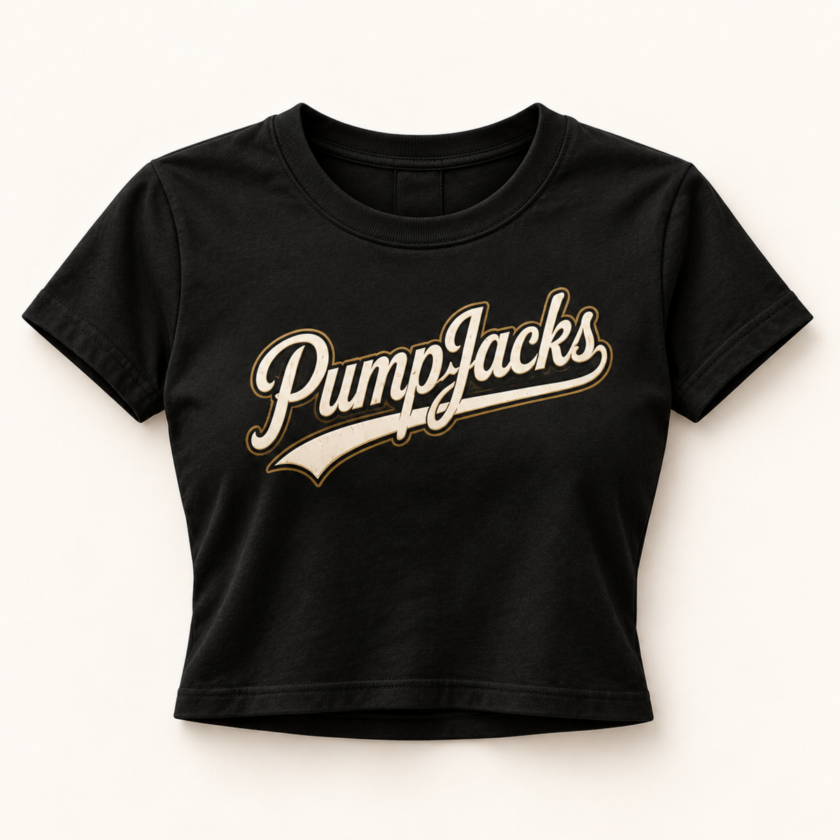 A black short-sleeve crop top t-shirt featuring a retro-style 'PumpJacks' logo printed across the chest in cream with a gold outline, displayed flat against a light beige background.
