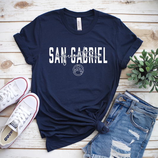 Navy blue t-shirt with 'San Gabriel' print on a wooden surface with sneakers and shorts.