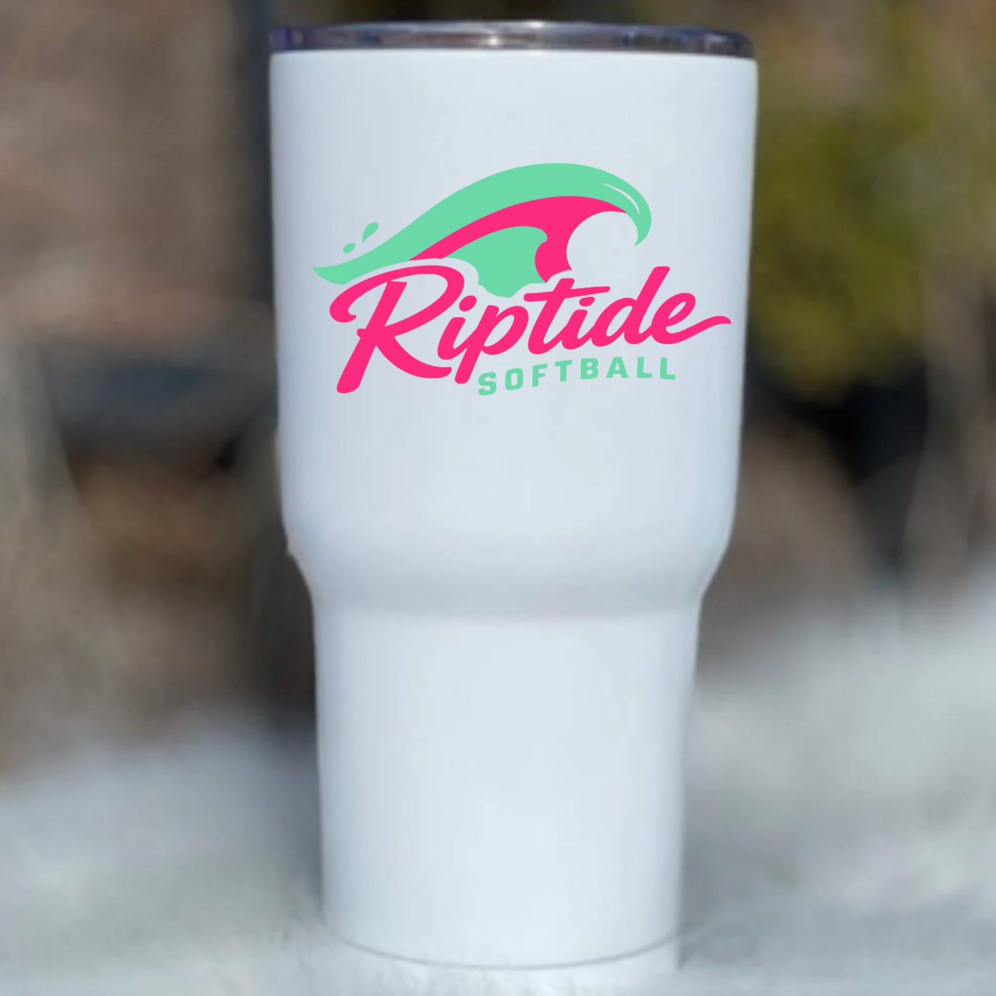 White tumbler with 'Riptide Softball' logo on a blurred background