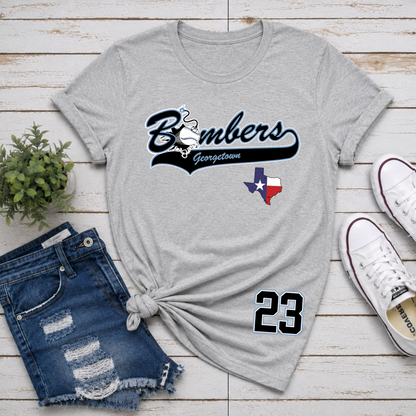 Gray t-shirt with 'Bombers Georgetown' design, blue shorts, and white sneakers on a wooden surface.