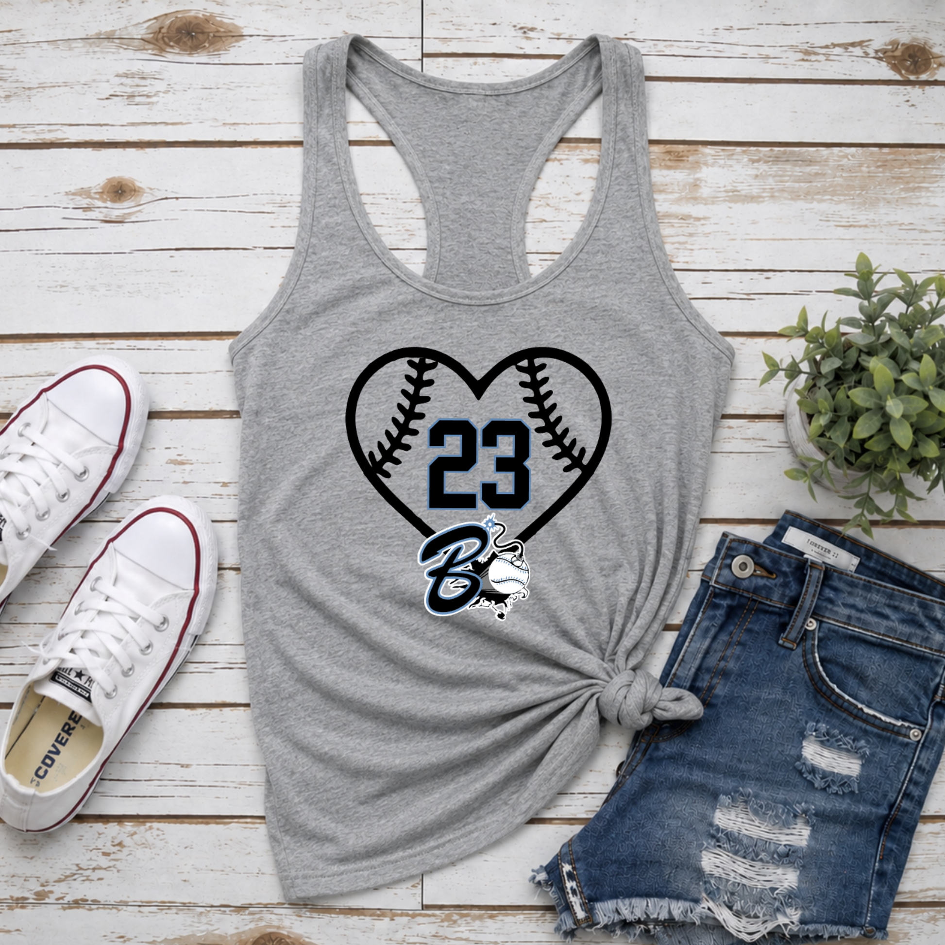 Gray tank top with heart and number design, paired with denim shorts and sneakers on a wooden surface.