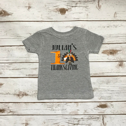 Gray t-shirt with a turkey graphic and text on a wooden surface