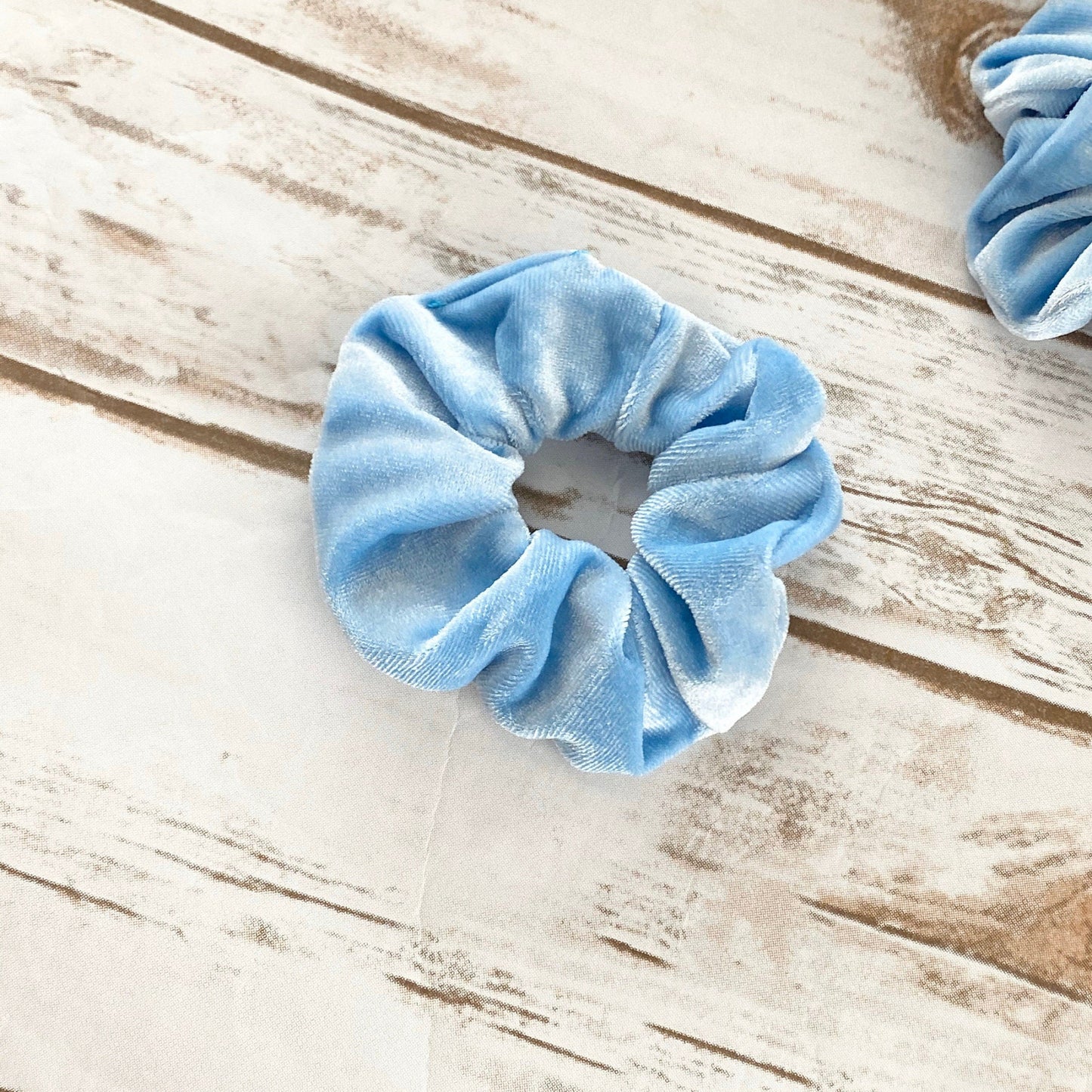 Blue scrunchie on a wooden surface