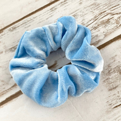 Blue scrunchie on a wooden surface