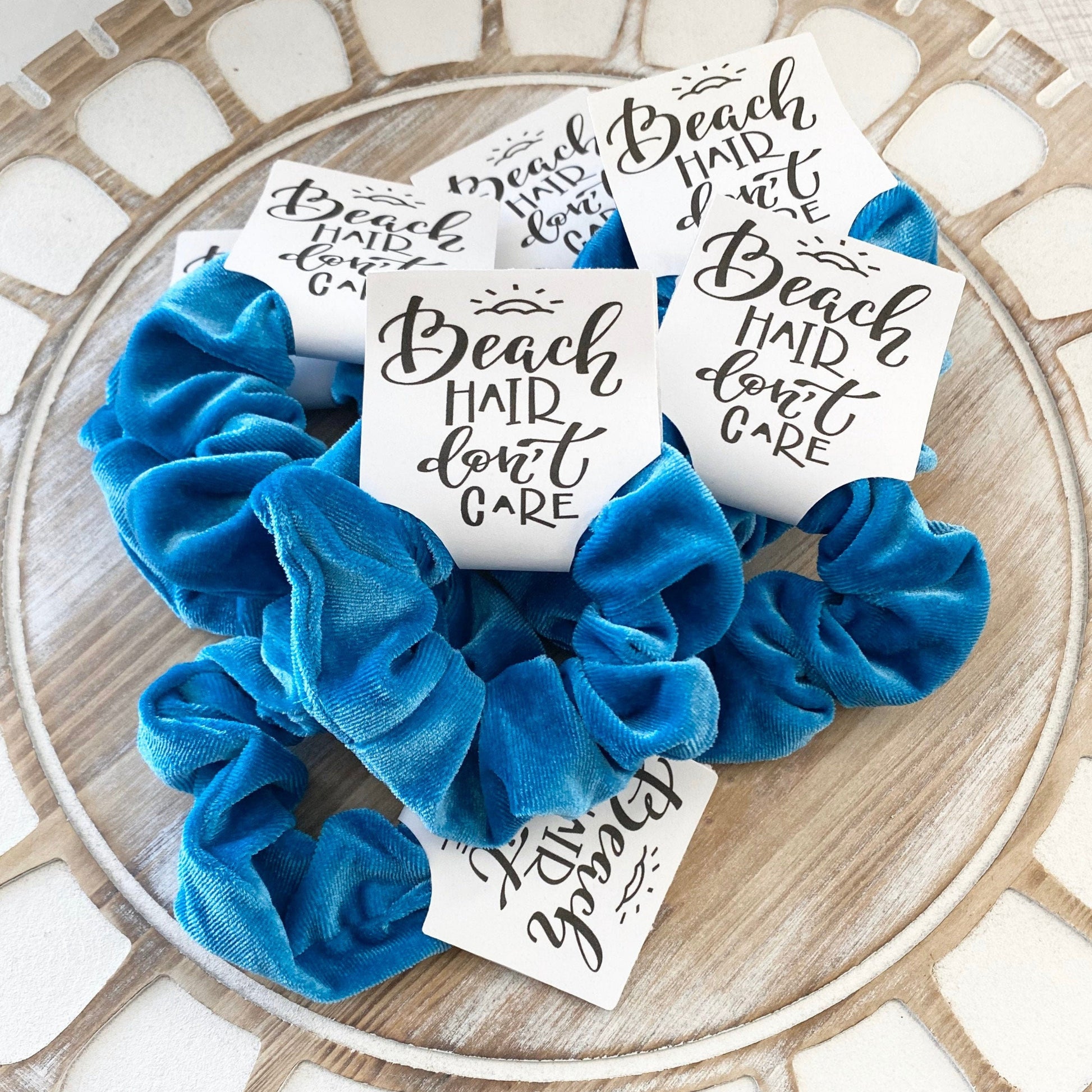 Blue scrunchies with motivational cards on a decorative surface
