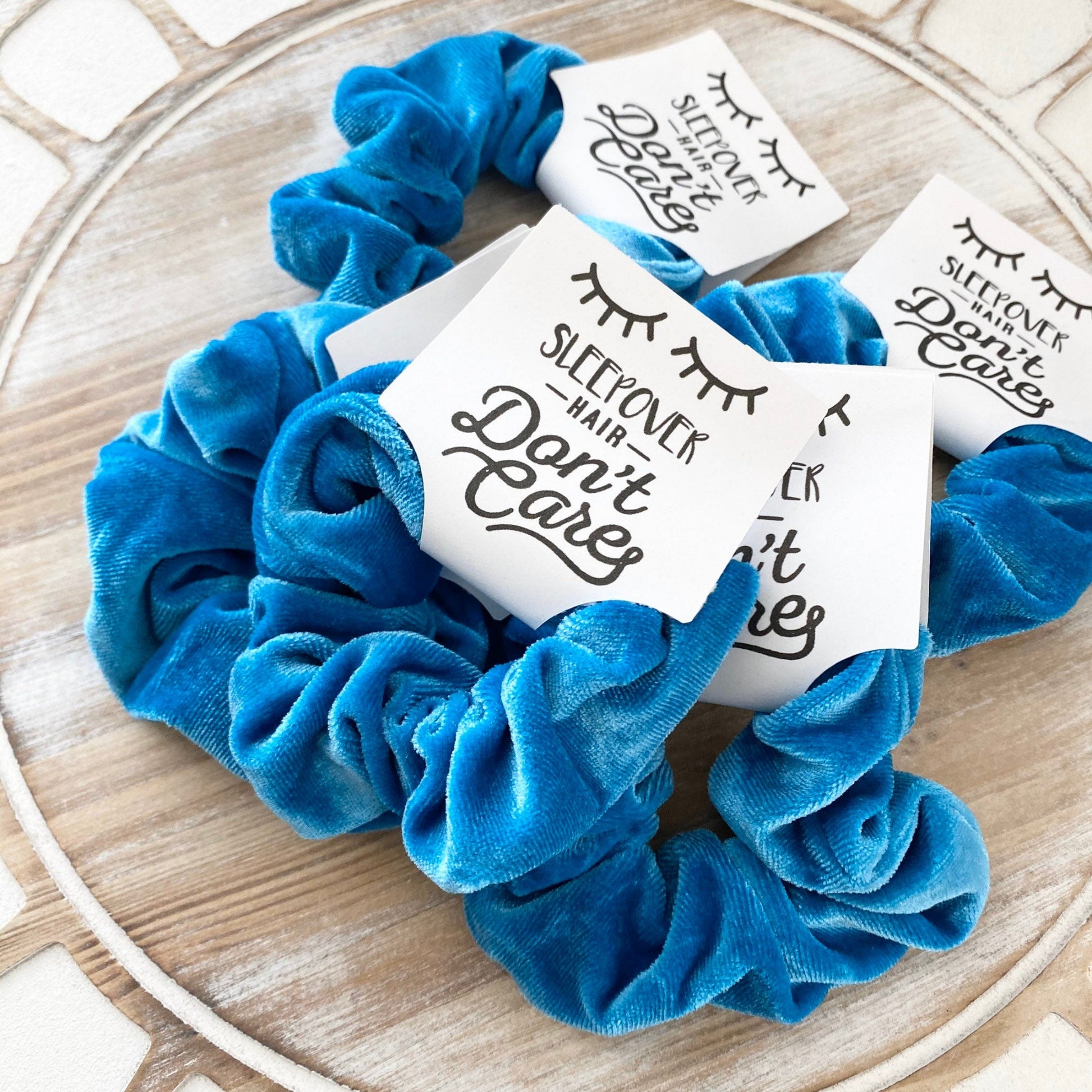 Blue scrunchies with printed cards on a decorative plate