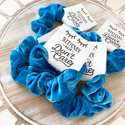 Blue scrunchies with printed cards on a decorative plate
