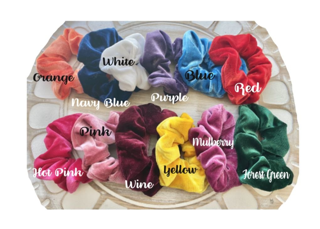 Assorted colorful scrunchies on a wooden board with color labels.