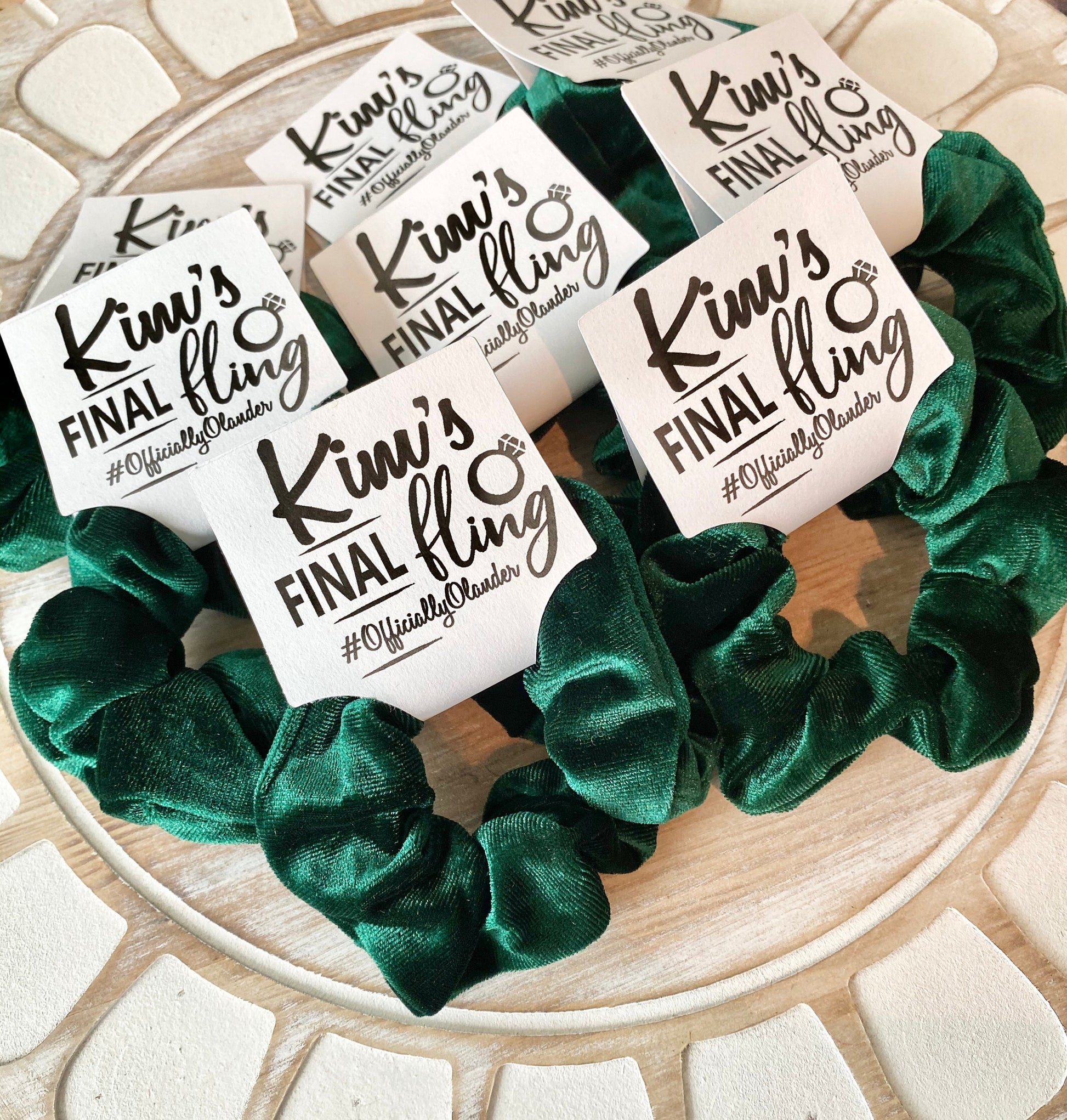 Green scrunchies with 'Kim's Final Fling' labels on a decorative plate.