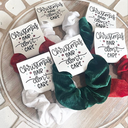 Set of hair scrunchies with 'Christmas Hair Don't Care' labels on a decorative surface.