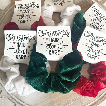 Green scrunchie with 'Christmas Hair Don't Care' tag on a decorative background