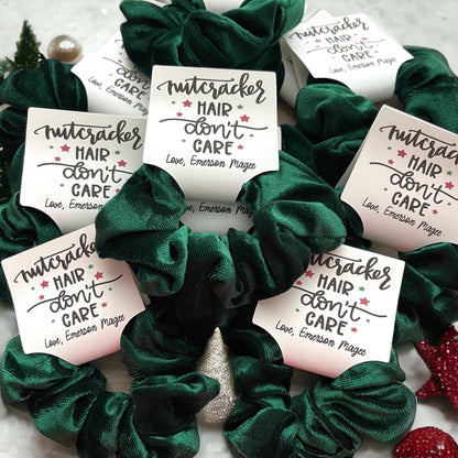 Green scrunchies with 'Nutcracker Hair Don't Care' labels on a white background