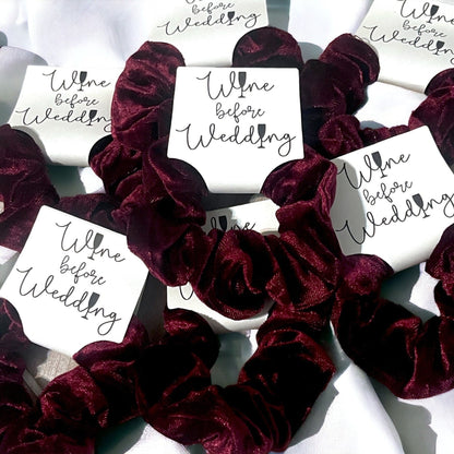 Burgundy scrunchies with 'Wine before Wedding' cards on a white background