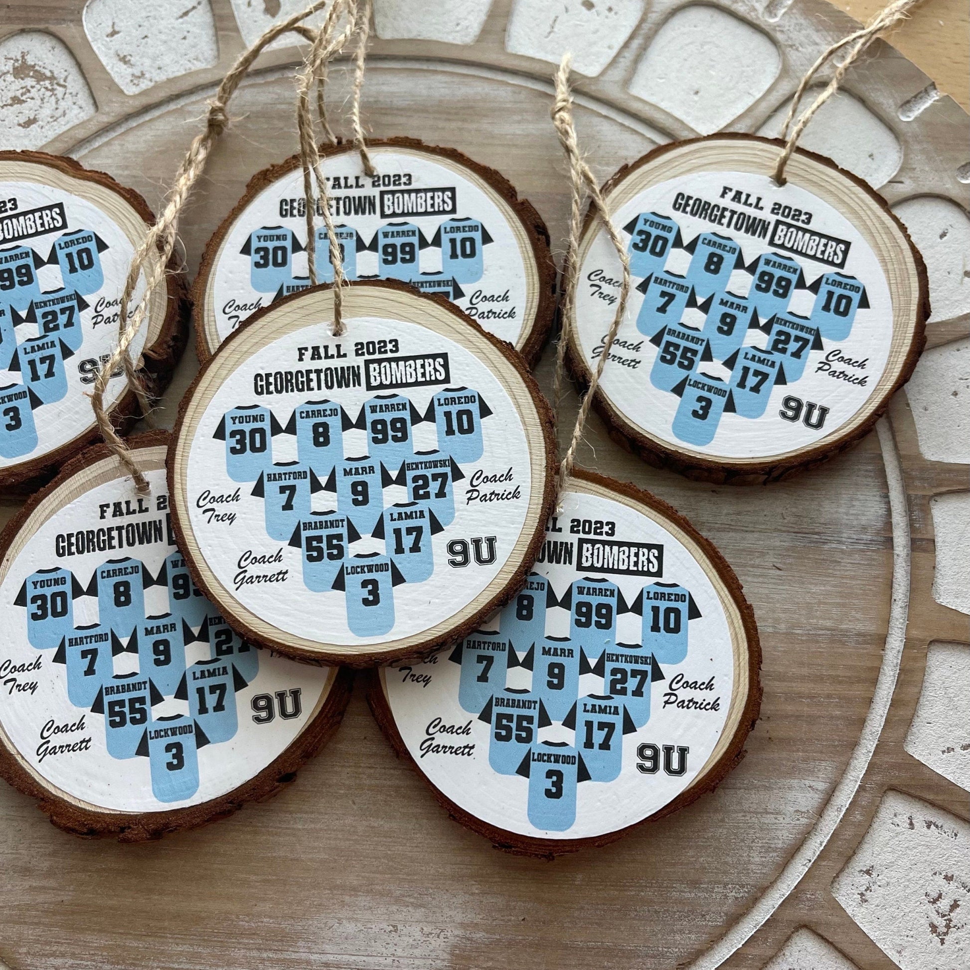 Wooden ornaments with Georgetown Bombers designs on a decorative surface