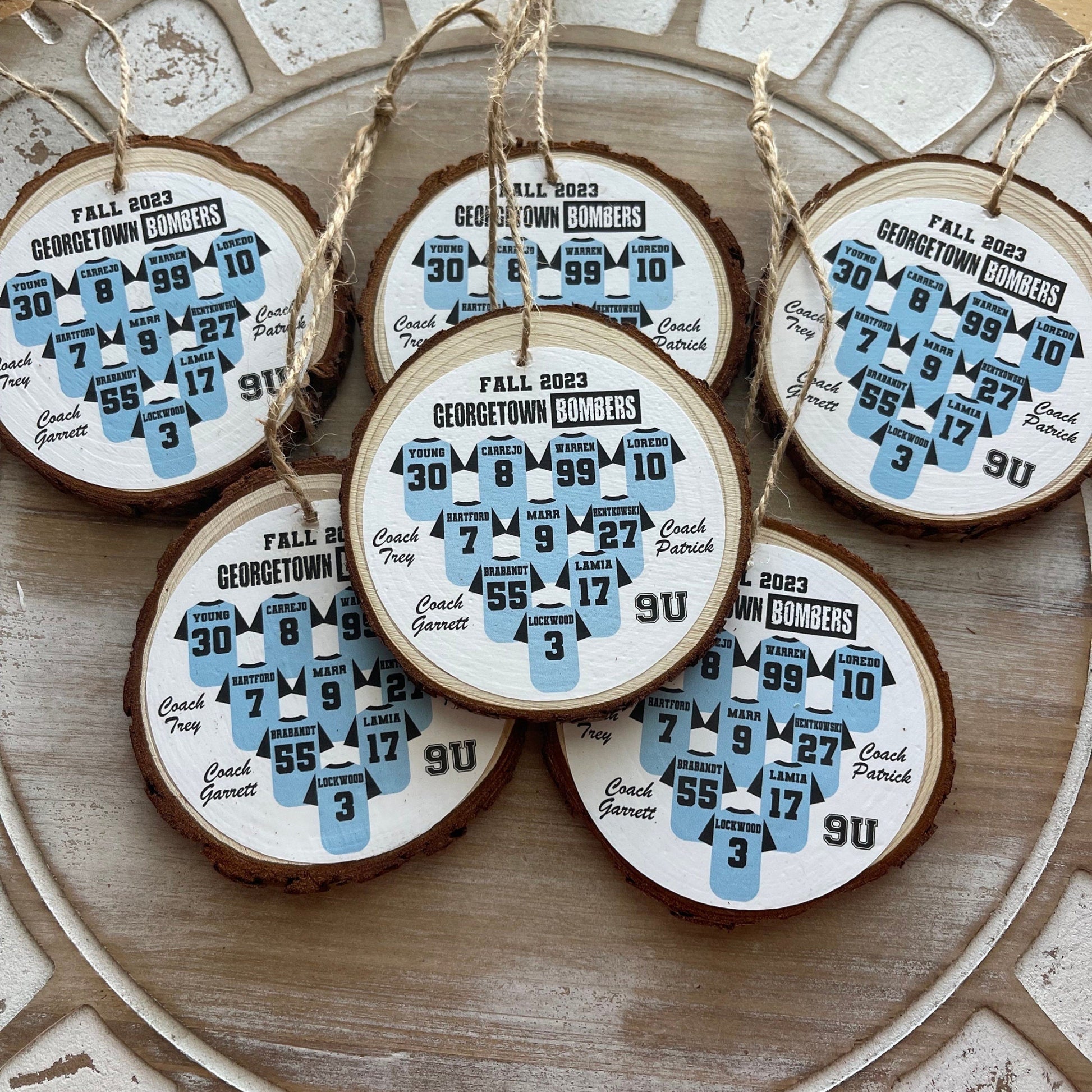 Wooden ornaments with printed designs on a decorative plate