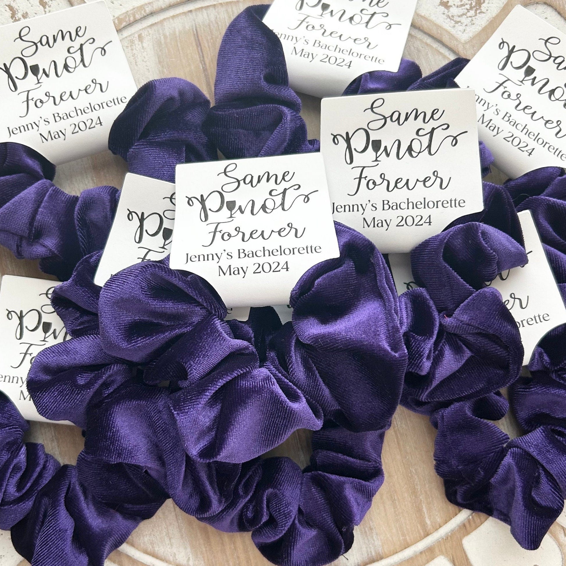 Purple scrunchies with personalized cards on a decorative plate