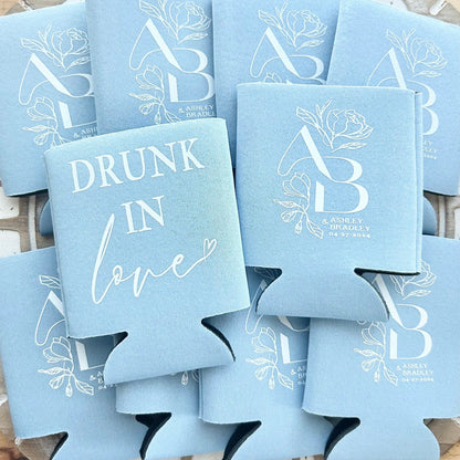 Stack of blue can coolers with 'Drunk in Love' text and AB & L brand logo.