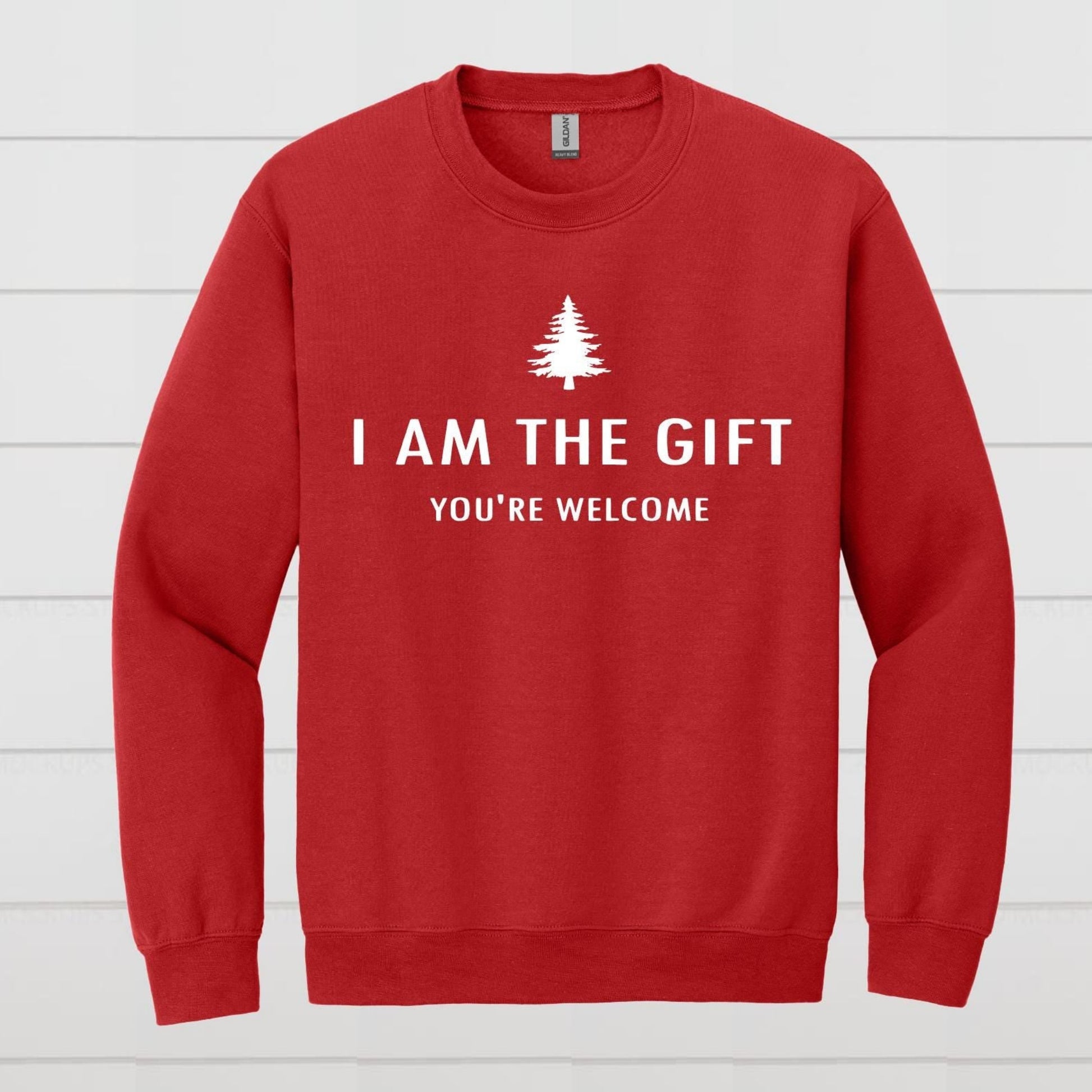 Red sweatshirt with white text and a tree graphic on a white wooden background
