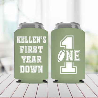 Two green can coolers with text on a blurred background
