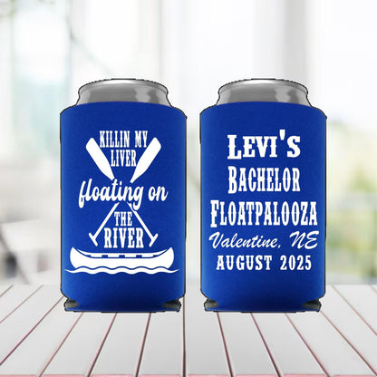 Two blue can coolers with white text on a wooden surface.