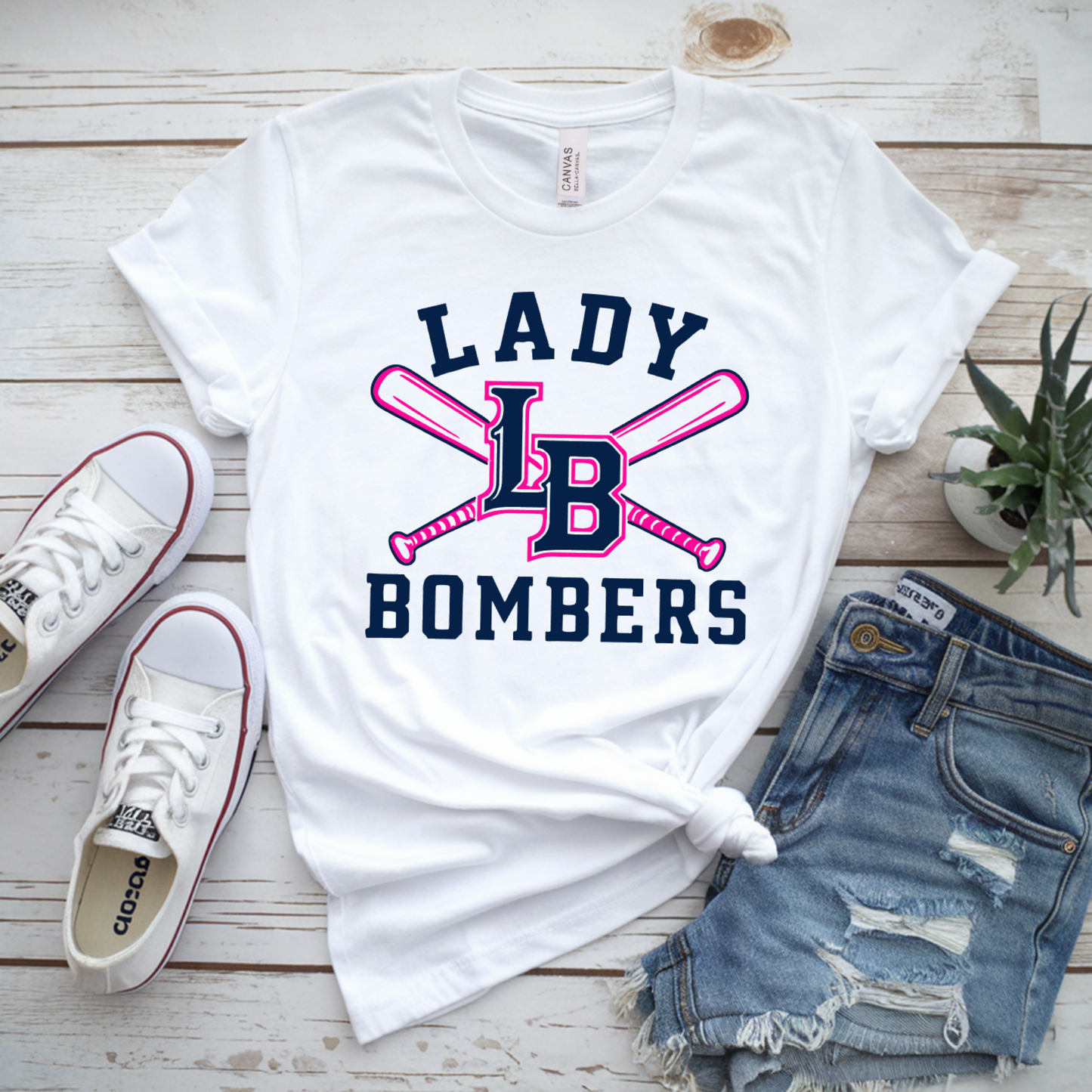 White Lady Bombers Softball tee with navy and pink LB logo and crossed softball bats