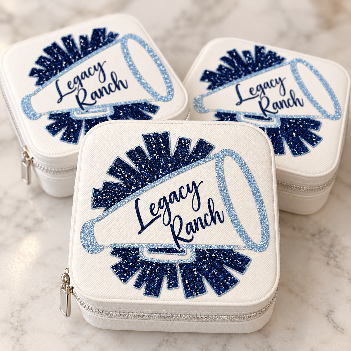 White Legacy Ranch cheer accessory case with navy and powder-blue glitter megaphone design