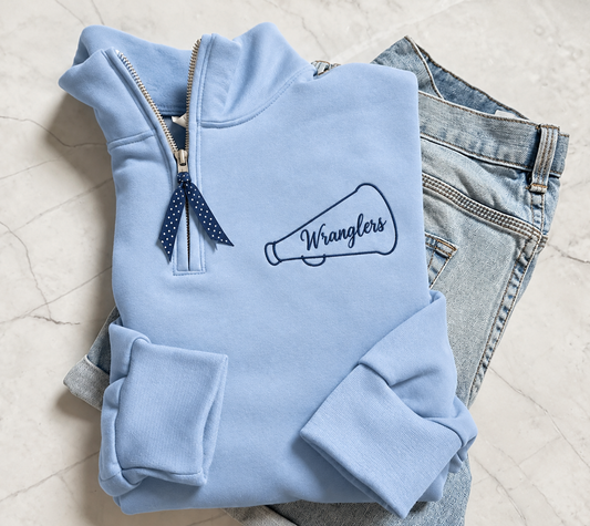 Powder blue Wranglers quarter-zip with navy embroidered megaphone and polka-dot ribbon zipper pull