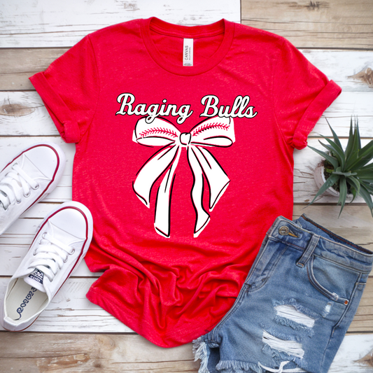 Red t-shirt with 'Raging Bulls' graphic, white sneakers, and denim shorts on a wooden surface.