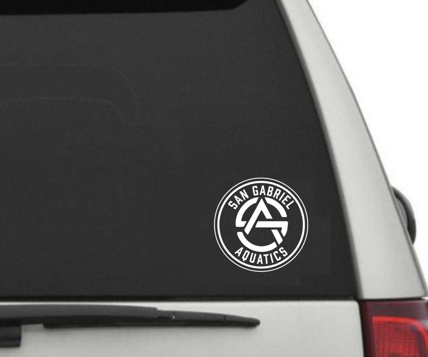 Car window with a 'San Gabriel Aquatics' decal on a white background