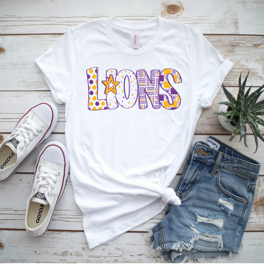 White t-shirt with 'LIONS' print, Converse shoes, and denim shorts on a wooden surface.
